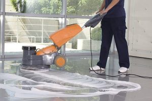 A Man worker cleaning the floor with scrubber machine. image. High quality photo